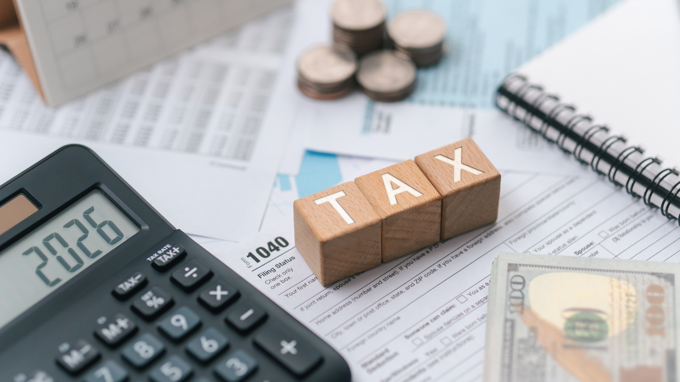 image of a calculator and blocks that spell tax